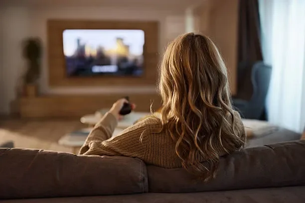 Home streaming setup — couch, large screen, live sports and movies