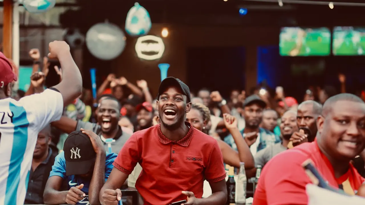 Diverse fans cheering at sports bar watching World Cup 2026 with Zynora streaming
